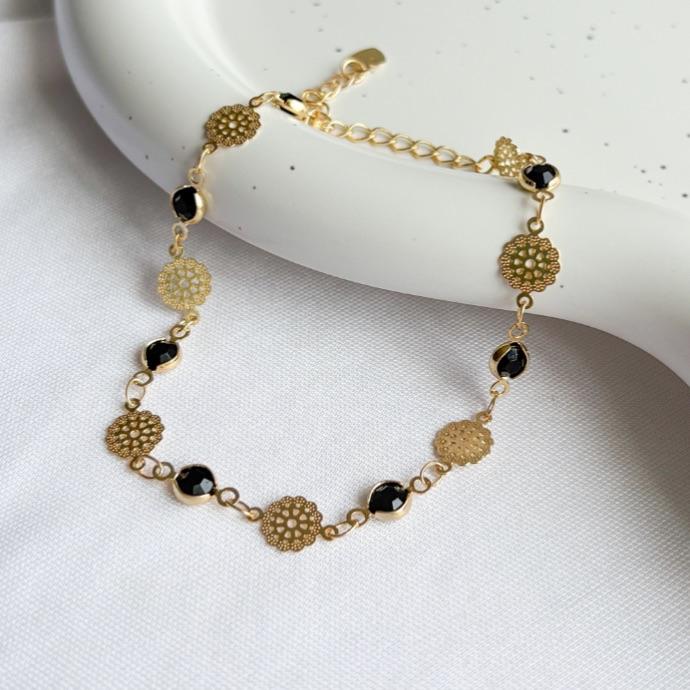 PULSEIRA MEDALHAS FLORES E PEDRAS PRETAS B. OURO